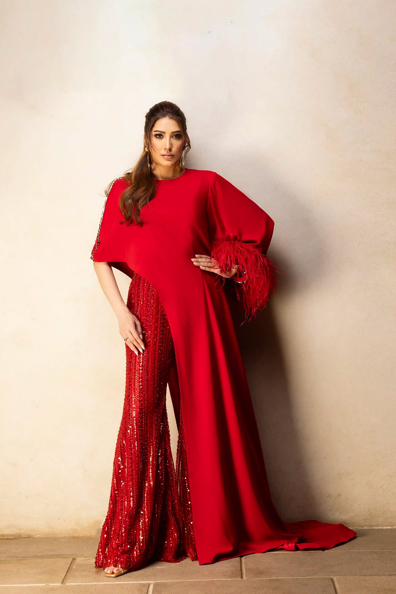 Red asymmetrical top with beaded pants