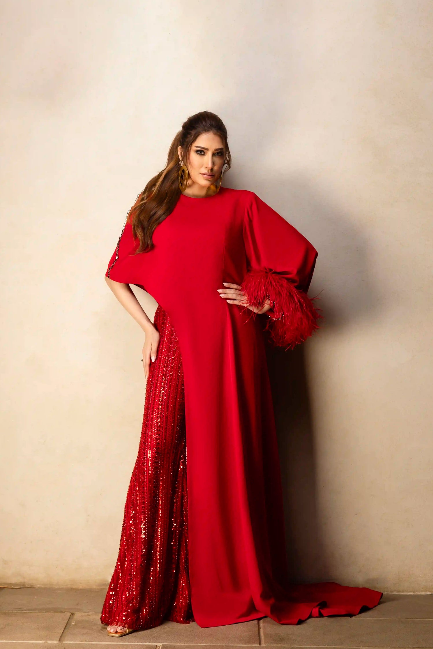 Red asymmetrical top with beaded pants