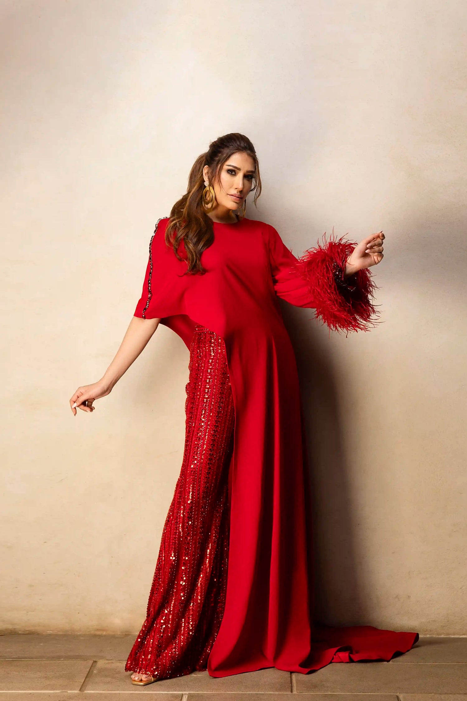 Red asymmetrical top with beaded pants